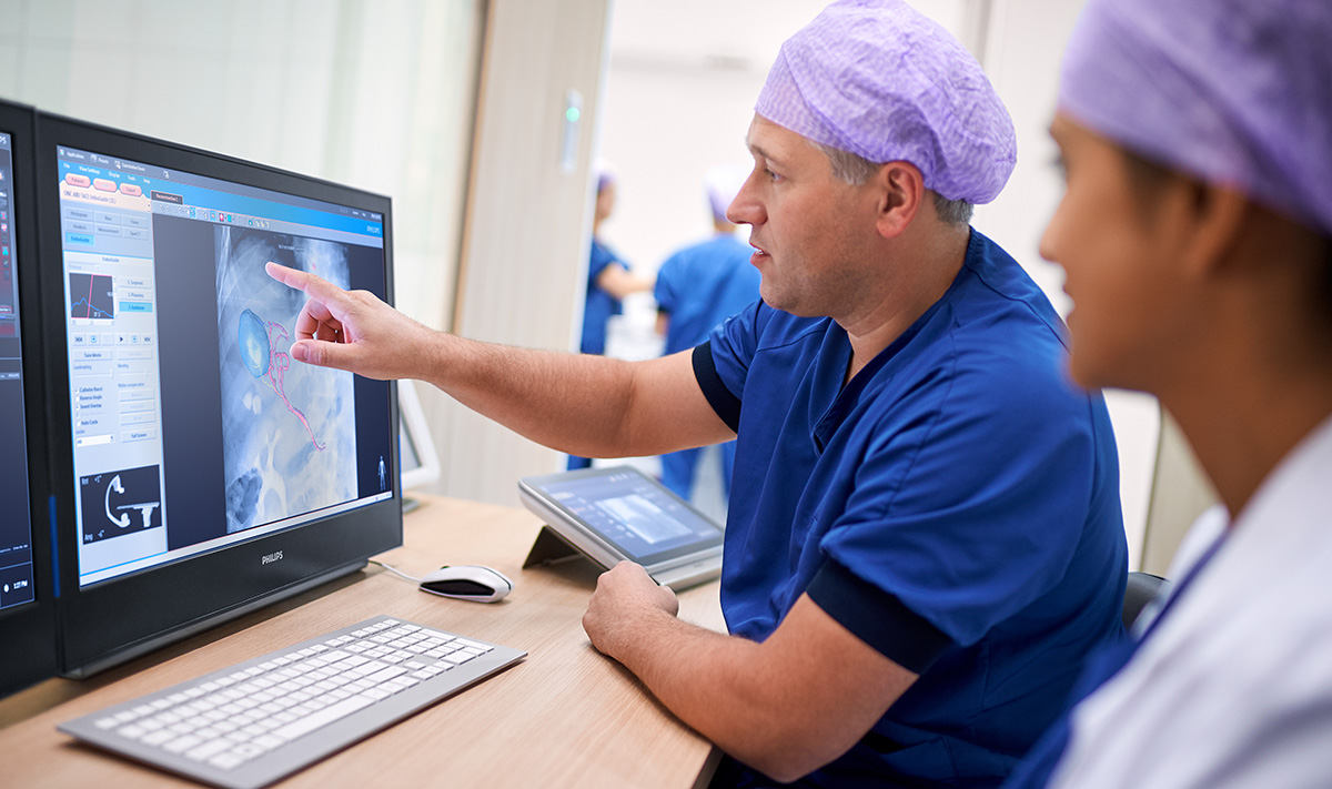 Physicians pointing at a screen with intravascular images